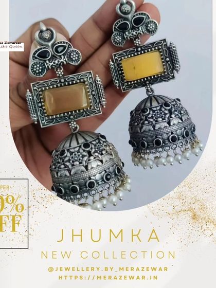 This is one of my classic oxidized jhumkas, shown here with a warm yellow stone. The design features a rectangular top piece and a detailed dome with tiny pearl accents, offering a timeless ethnic look.
