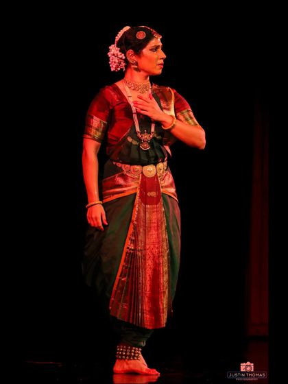 A gesture of self-reflection, perhaps portraying a heroine looking at her own reflection. The internal world of the character is brought to life on stage.
