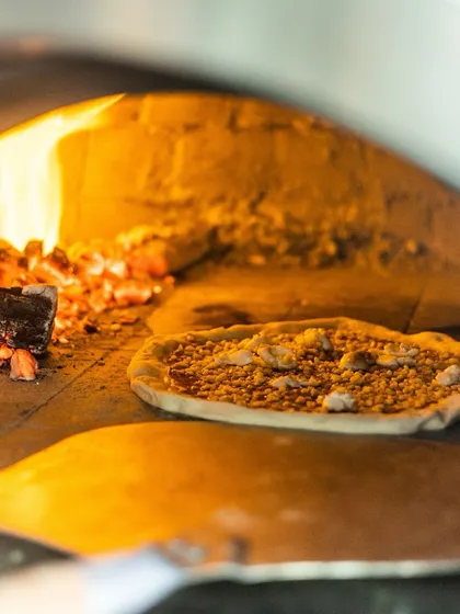 A little fire, a lot of flavor. My wood-fired pizza never disappoints, seen here baking next to the hot coals.