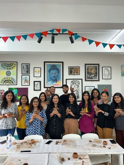 A happy group of participants from a pottery workshop. It's a great way to de-stress and connect with your creative side.
