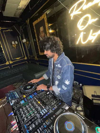 In my element, surrounded by the cool decor and neon lights of the club, focused on the music.