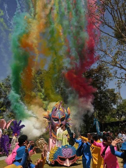 The carnival float entry, complete with a massive burst of rainbow-colored smoke, creating a stunning visual spectacle.
