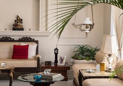 A detail shot from the Kaira residence, highlighting the neo-classical elements and neutral color palette. The space is adorned with traditional carved furniture and carefully selected decor to evoke a feeling of calm and tranquility.