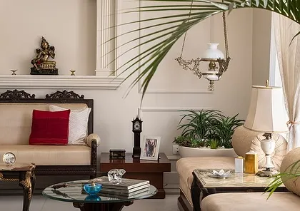 A detail shot from the Kaira residence, highlighting the neo-classical elements and neutral color palette. The space is adorned with traditional carved furniture and carefully selected decor to evoke a feeling of calm and tranquility.