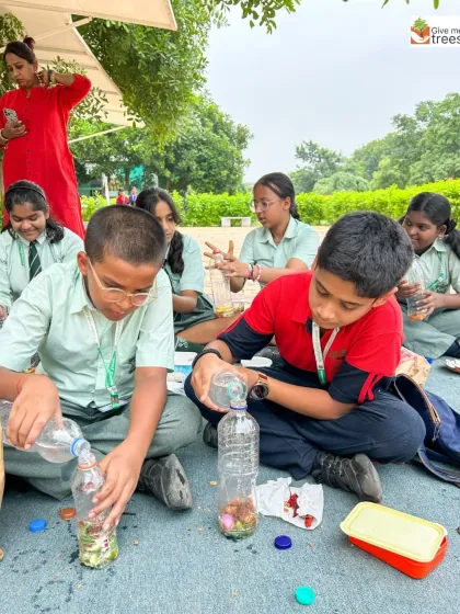A group of students works together to create bio-enzymes from fruit peels in used plastic bottles, learning about waste upcycling in a very practical way.