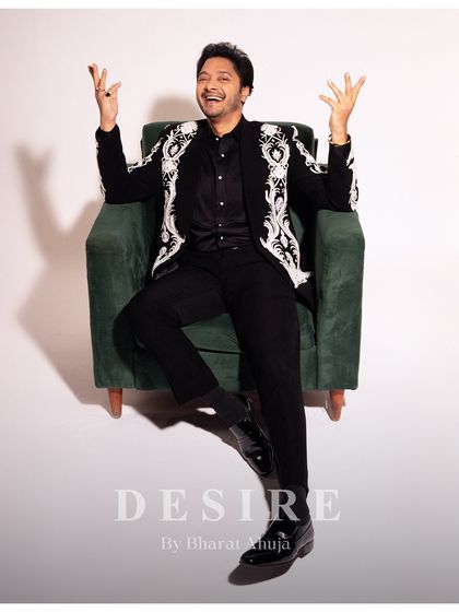 Charisma, tailored. This shot captures the playful yet powerful personality of a man comfortable in his own skin and in his custom-fitted jacket. The design is meant to empower and express.