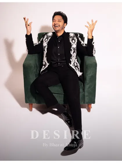 The joy of wearing something truly unique. This shot captures the personality of the black embroidered blazer, a piece that is both formal and full of life.