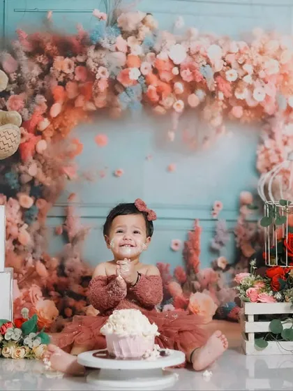 A first birthday is a huge milestone. This cake smash session, set against a beautiful floral backdrop, is all about celebrating that 'one-derful' year with joy, smiles, and a little bit of sweet mess.