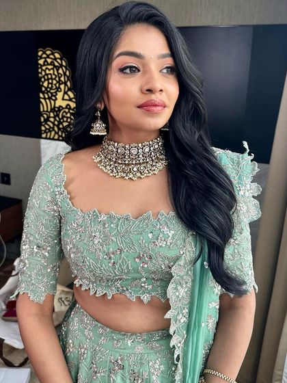 A beautiful three-quarter profile, showing the soft contouring and the way the makeup enhances her natural features.