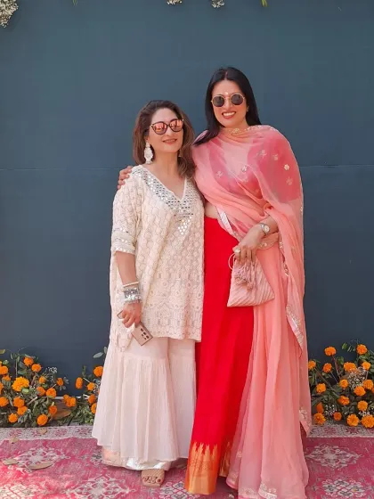 Celebrating Holi in style at the Travancore Palace. This look combines a red saree with a peach dupatta for a colorful, festive feel that’s perfect for a high-end celebration.