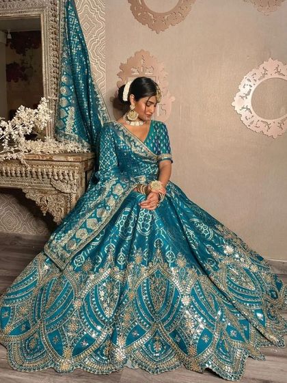 This is one of my most popular rental lehengas for sangeet functions. The rich teal color and gota patti work are perfectly complemented by the simple choker and earrings.