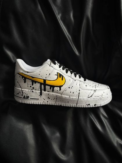 A side profile of the yellow drip custom sneaker.