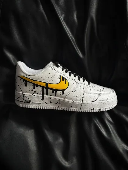 A side profile of the yellow drip custom sneaker.