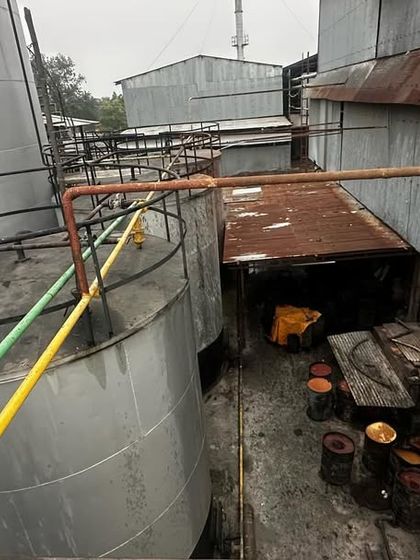 An overhead view of the storage tanks at the client's oil refinery, demonstrating the scale of the industries we serve.
