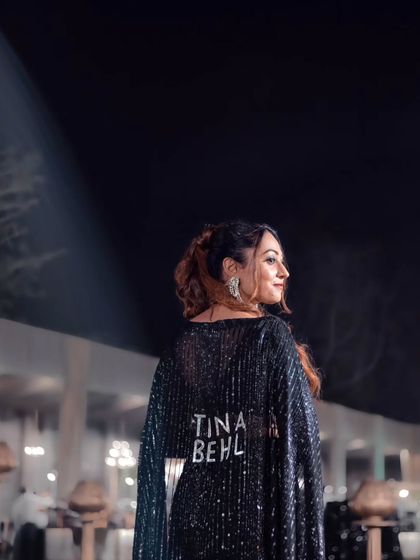 A profile shot showing off my custom "Tina Behl" cape. It's a powerful branding statement and a reflection of my confident personality.