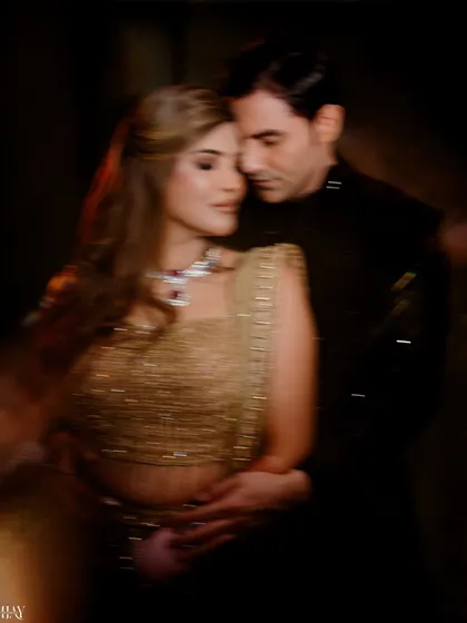 An artistic, soft-focus shot of the couple in a close embrace, creating a dreamy and romantic atmosphere.