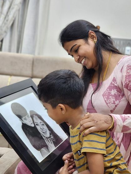 A mother and son sharing a quiet moment looking at their new family portrait. These are the connections I strive to create with my art.