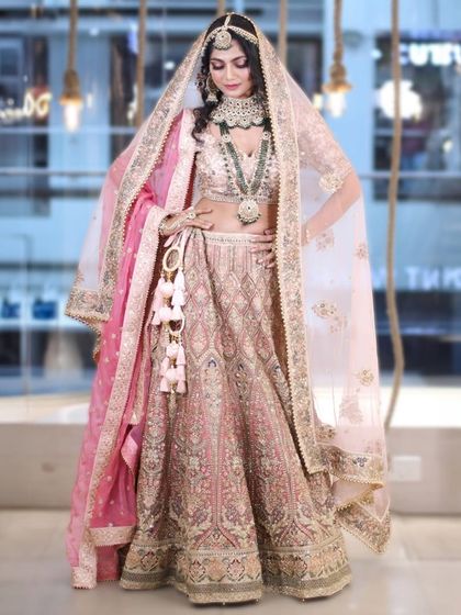 A modern fairytale look. This pastel pink bridal lehenga with delicate floral embroidery and a double dupatta is soft, romantic, and absolutely unforgettable.