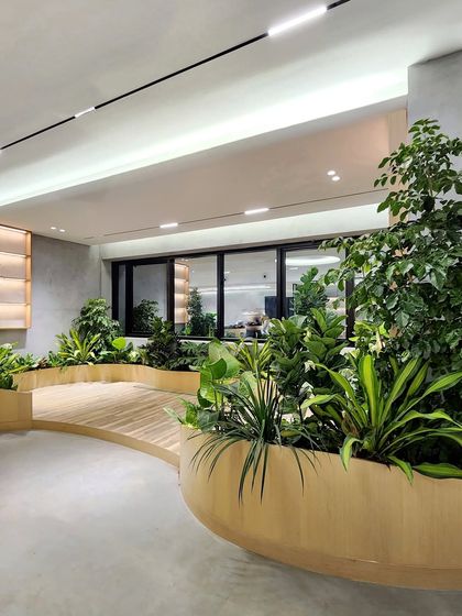 This thoughtfully designed office in Hyderabad is a harmonious blend of nature and innovation. The lush planter beds are a key feature, promoting well-being and creating a truly modern workspace.