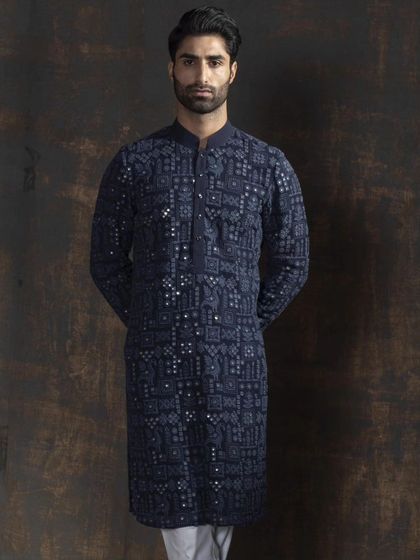 The full view of the navy blue embroidered kurta. The geometric pattern adds a modern feel to the traditional silhouette, creating a look of unparalleled sophistication.