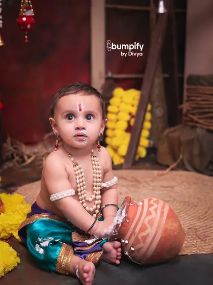Caught in the act. This little Kanha has his hands and face covered in 'makkhan', making for a playful and authentic Janmashtami moment.