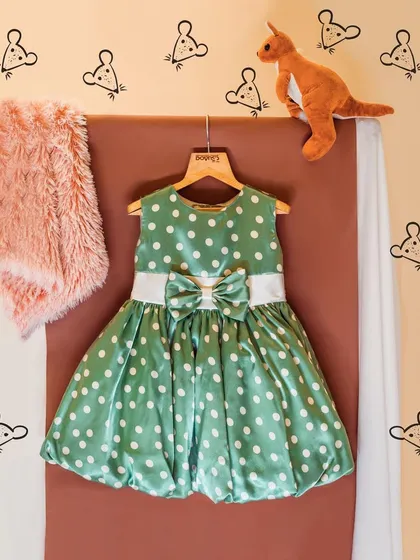 This green polka dot bubble dress is styled with a fluffy pink scarf and a toy kangaroo. It shows how my dresses can be a fun part of a child's imaginative world.