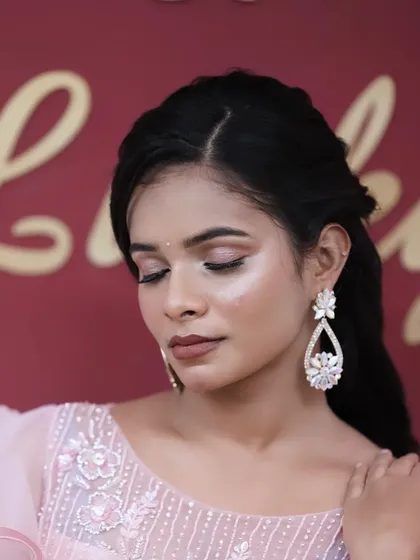A close-up of a beautiful soft glam look, with shimmery pink eyeshadow and a flawless, glowing complexion. Perfect for an evening event.