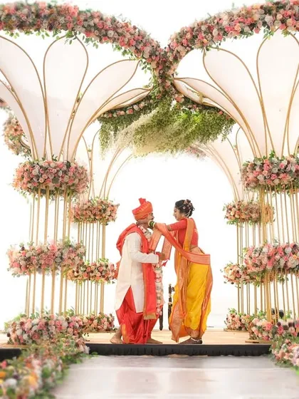 A playful moment during the ceremony, captured from a distance to showcase the grandeur of the wedding decor.