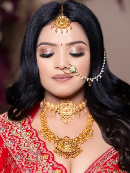 A close-up of the South Indian bridal look, showing the soft shimmer on the eyes and the perfectly defined lips, all done by a student during their portfolio shoot.