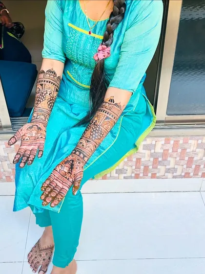Another shot of the beautiful engagement mehendi, showing the intricate details on the arms and the happy client.