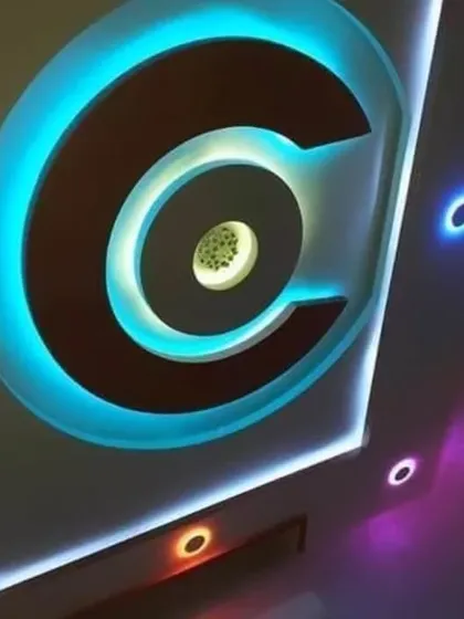 A creative PVC design featuring a large 'C' shape with bright cyan backlighting. The different colored spotlights on the side add a playful touch.
