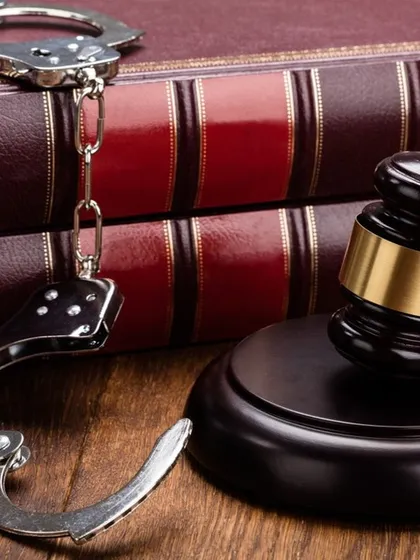 Legal matters require legal solutions. The law books, gavel, and handcuffs represent the serious nature of criminal law, a field where I deliver results for my clients.