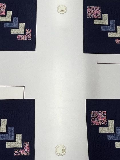 A set of four placemats with a modern geometric design.