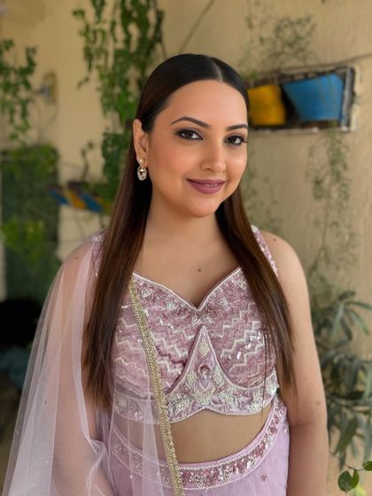 A portrait of the bride, her makeup looking fresh and radiant. The pink tones on her eyes, cheeks, and lips create a harmonious and beautiful look.