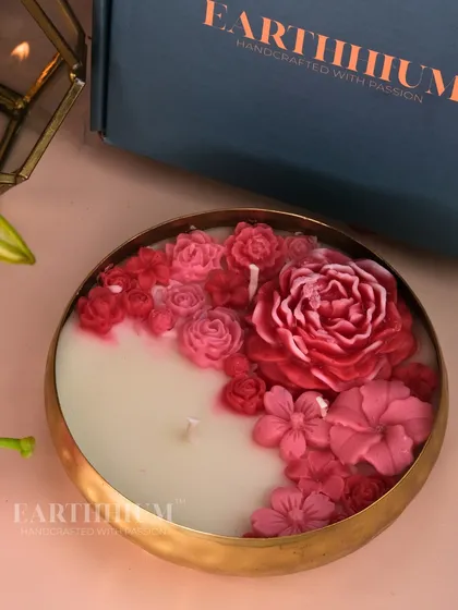 This Urli candle is a true labor of love, filled with a garden of hand-sculpted pink flowers. It's a large, multi-wick statement piece designed to be a stunning centerpiece, creating a warm and inviting atmosphere for gatherings or quiet evenings at home.