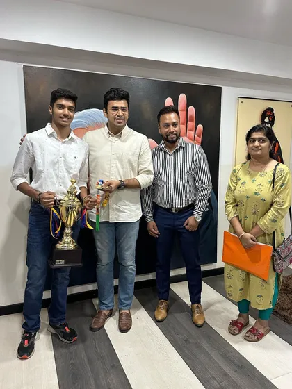 A full-length shot of Akash K J with his family and me during the felicitation by MP Tejasvi Surya.