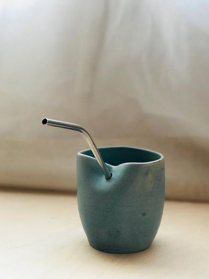 The "Sipura" cup with a metal straw. Its versatile design works perfectly for slow sipping or for use with a straw.