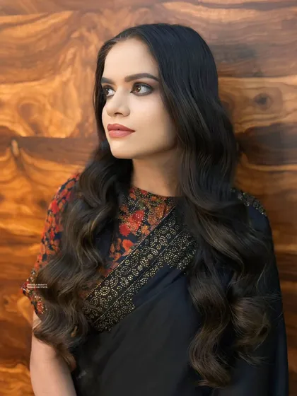 A side profile showing the soft waves in the hair and the beautifully blended makeup. This is a timeless look of sophistication.
