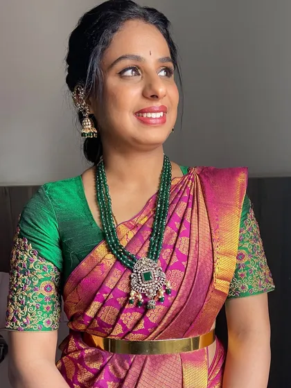 A soft and pretty look for a guest. The makeup is natural and glowing, paired with a traditional hairstyle that is perfect for a wedding ceremony.