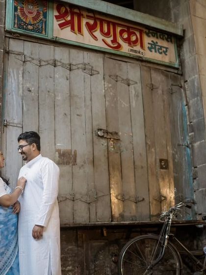 A classic pre-wedding portrait set against the rustic doors of an old market, telling a story of love in the heart of the city.
