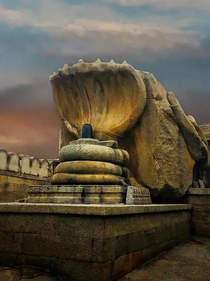 The unique Nagalingeshwara sculpture in Hampi, where a Shiva Linga is sheltered by a seven-headed cobra carved from a single rock.