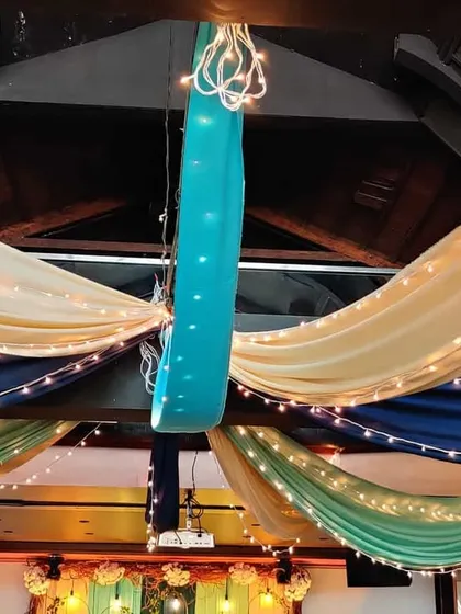 A closer look at the colorful ceiling drapes for the Mehendi ceremony. The combination of rich jewel tones and soft cream fabric, accented with lights, adds a celebratory feel to the space.