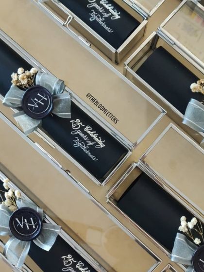 The complete invitation suite for the silver jubilee. Each scroll was placed in a glass box, creating a stunning presentation for every guest.