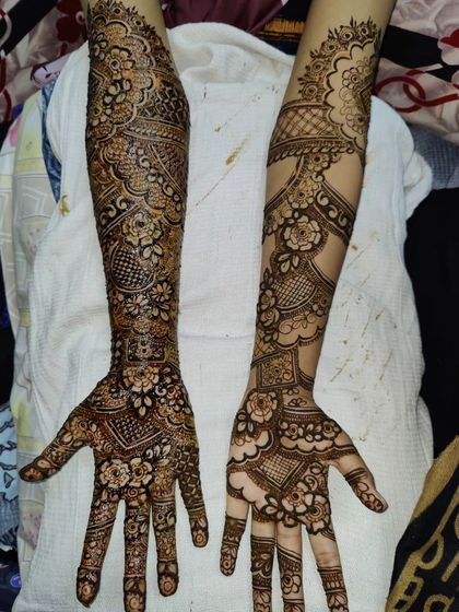 A classic bridal design with different but complementary patterns on each hand, showcasing a variety of motifs.