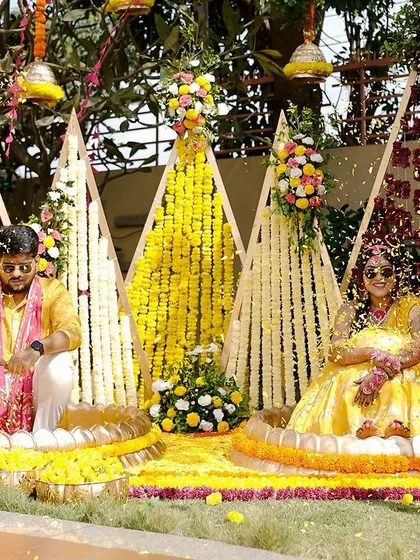 For Sukriti and Rahul's "Phoolon ki Haldi," we created this vibrant floral backdrop. Using geometric frames decorated with red and yellow flowers, we designed a cheerful and picturesque setting for the couple's ceremony.