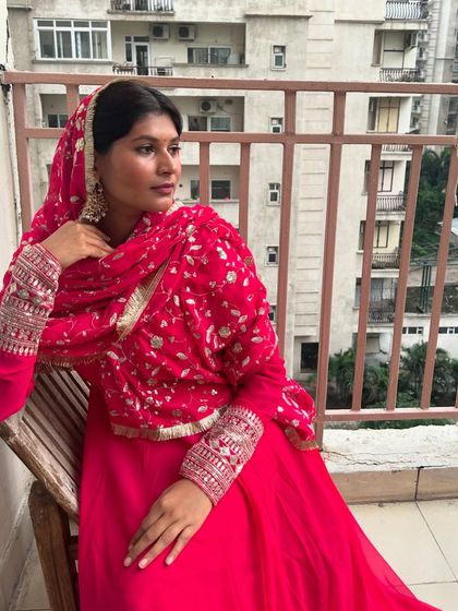 This seated pose showcases the intricate silver and gold embroidery on the dupatta and sleeves. It's these details that elevate a simple suit into a statement piece.
