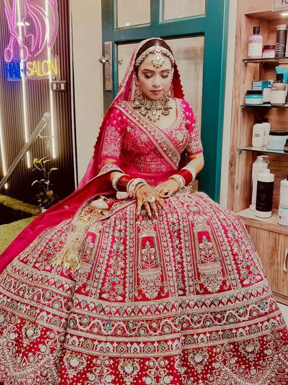A full-length view of our Sikh bride, showing how the makeup, hair, and magnificent lehenga come together. We ensure every element, from the maang tikka to the bangles, is perfectly in place.