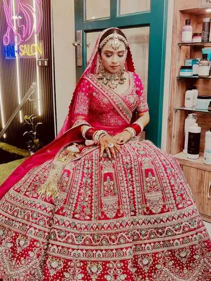 A full-length view of our Sikh bride, showing how the makeup, hair, and magnificent lehenga come together. We ensure every element, from the maang tikka to the bangles, is perfectly in place.