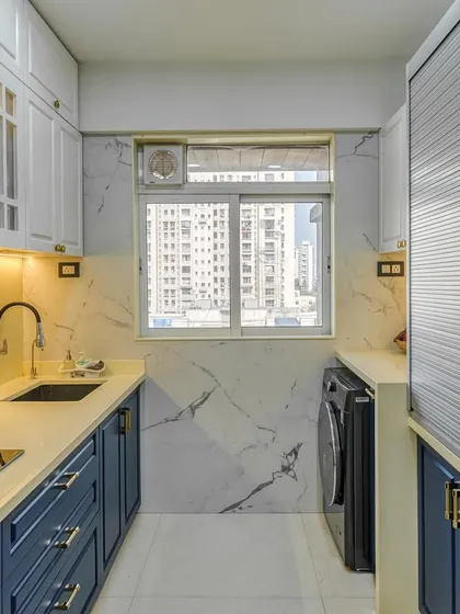 This parallel kitchen features a beautiful two-tone design with a PU finish. The classic white upper cabinets contrast perfectly with the bold blue lower cabinets, creating a vibrant and stylish space.