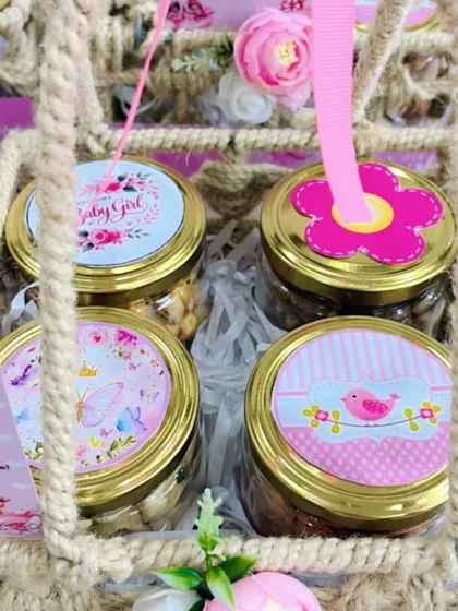 A close-up of the custom jar lids inside a jute basket favor. I can create various designs to match your announcement theme perfectly.